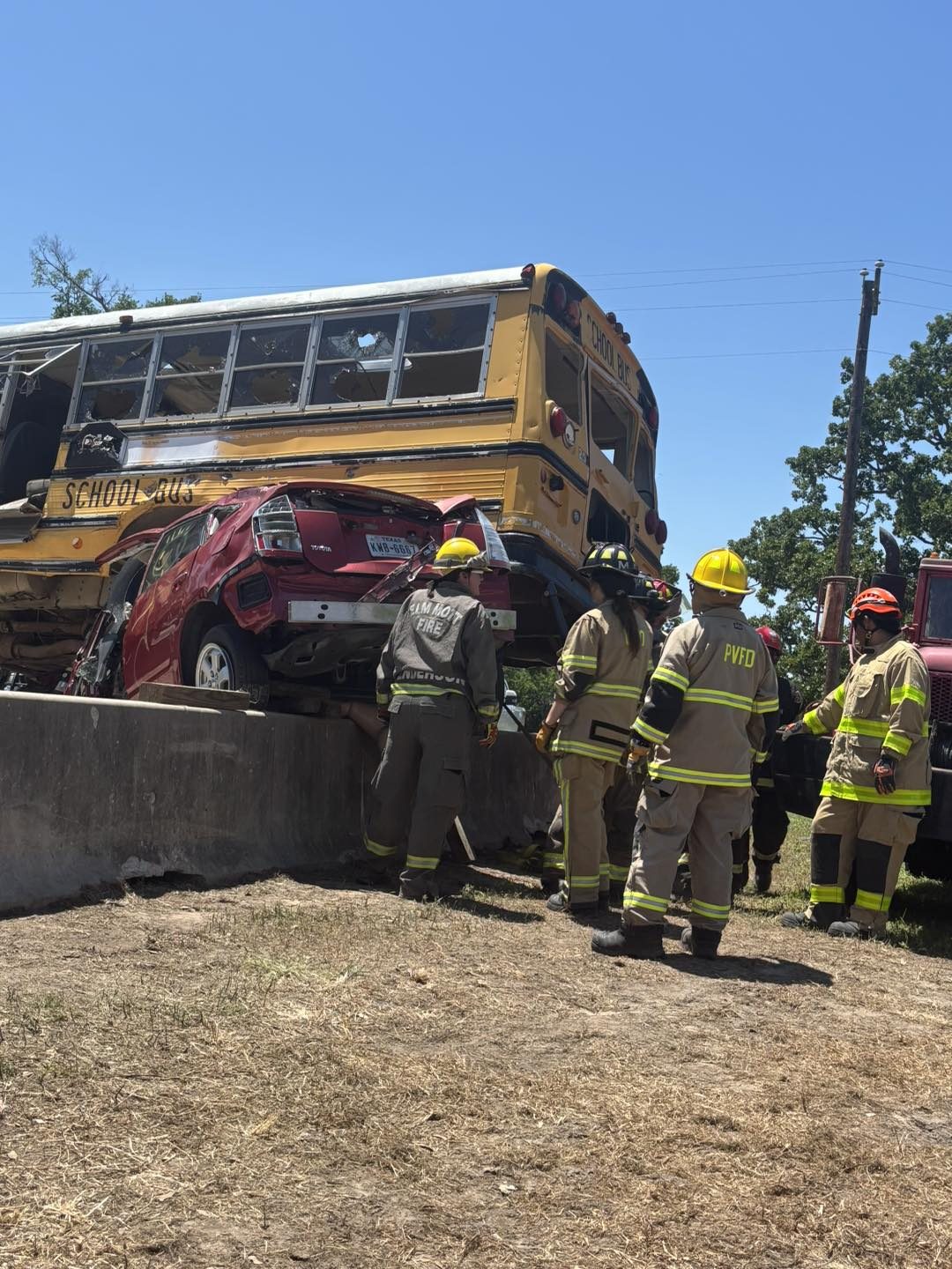 Extrication training with a school bus on top of a car