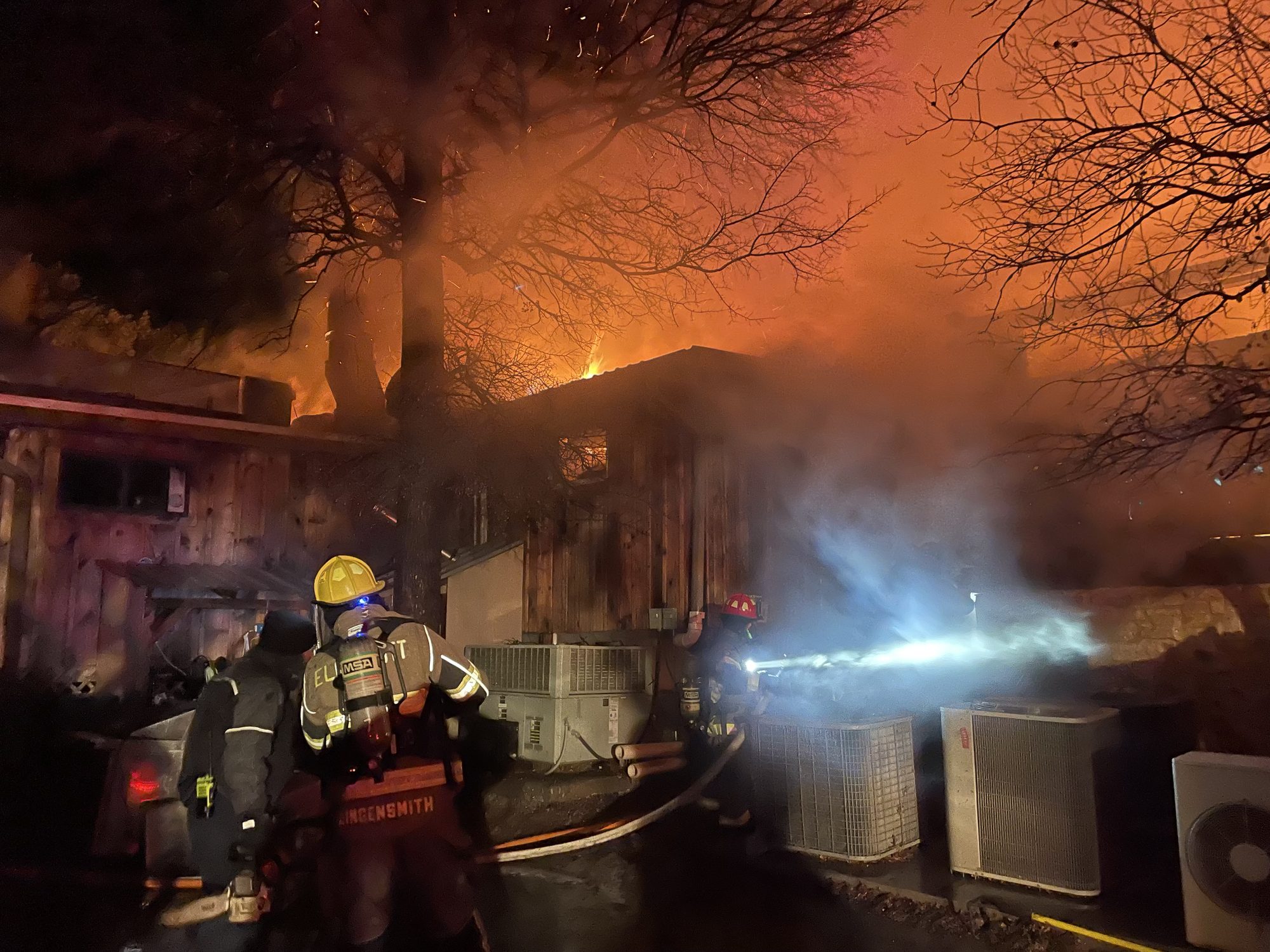 An Elm Mott member works a night structure fire