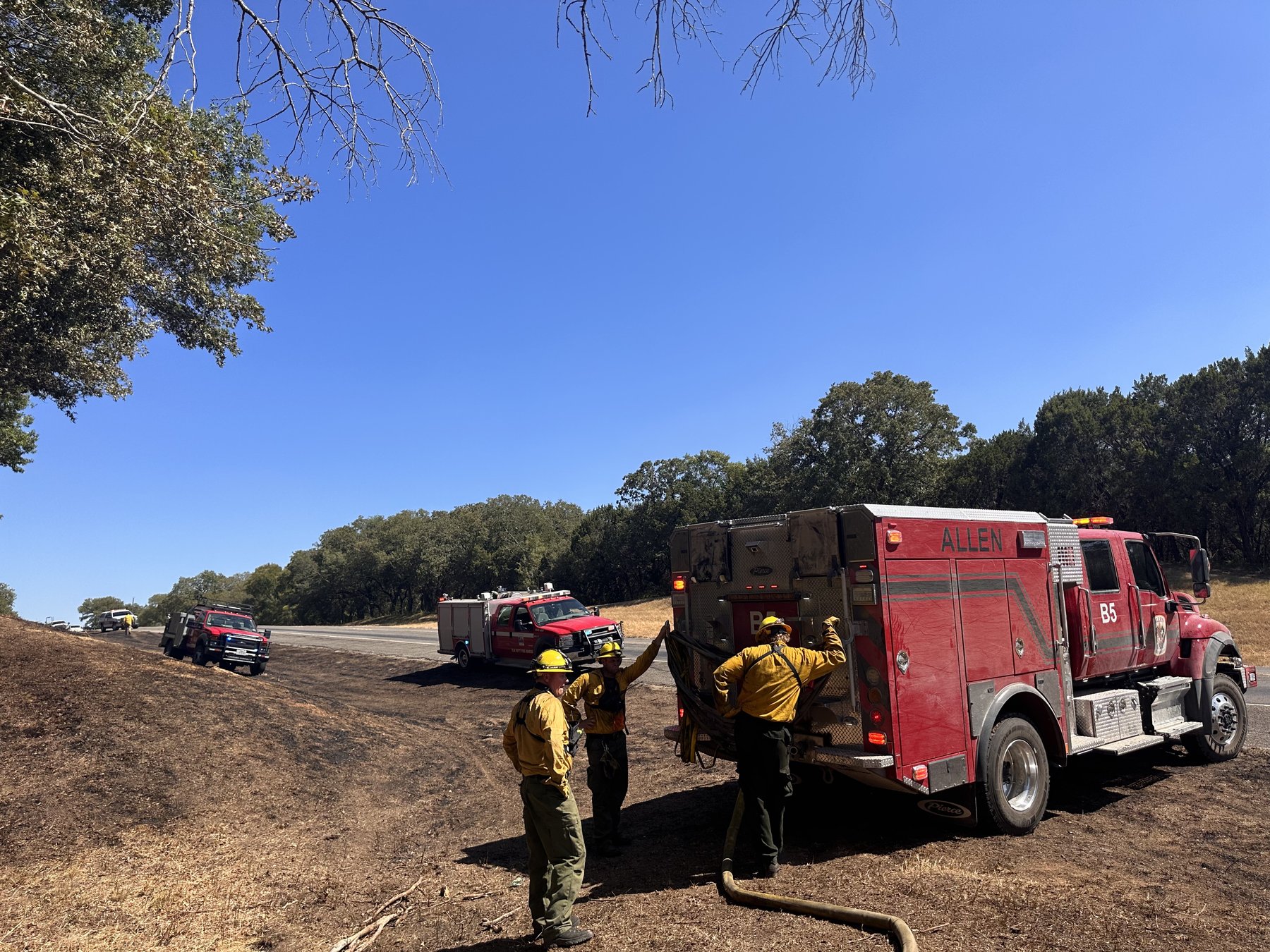 Brush trucks and crew working a grass fire
