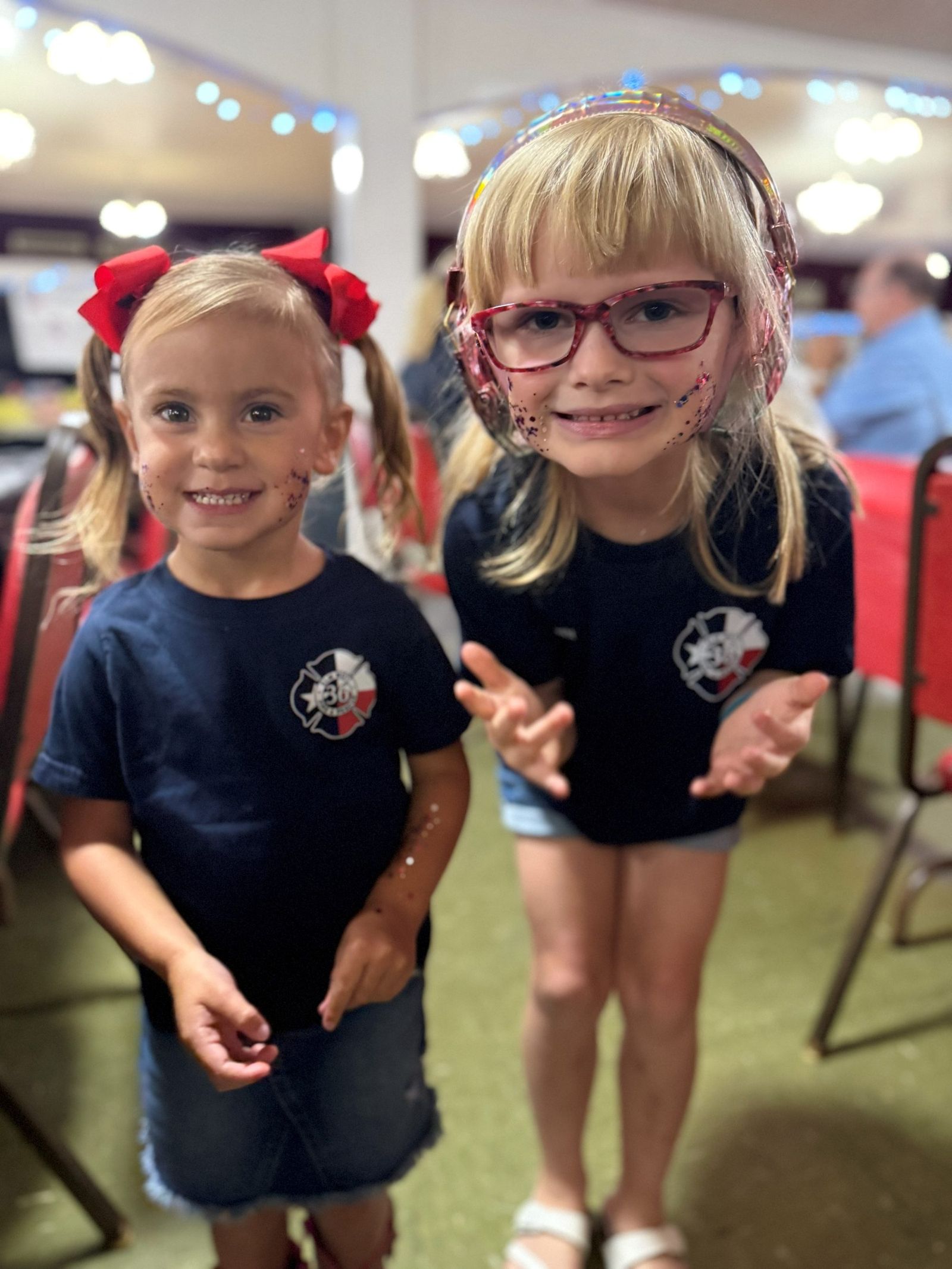 Two children in department shirts at the fundraiser